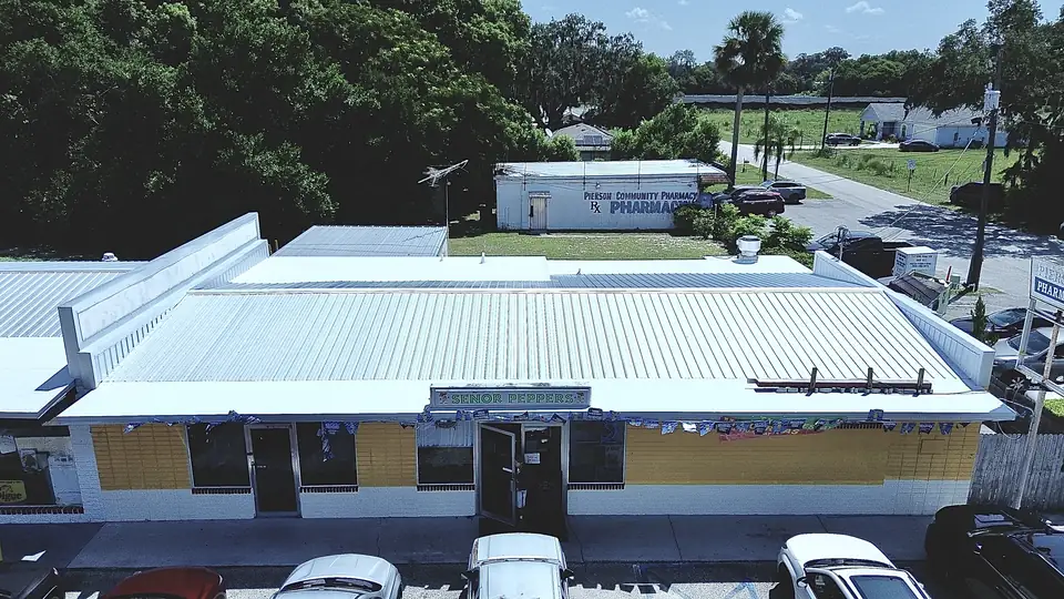 Strip of small commercial buildings with a new metal roof