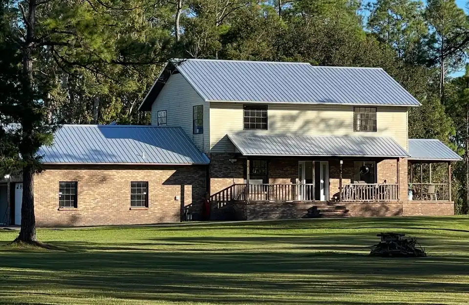 Two-story house with a new light gray metal roof